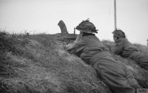 A Bren gunner watches for enemy movement on the banks of the Elbe River, at Hoopte near Winsen, 20 April 1945. © IWM (BU 4127)